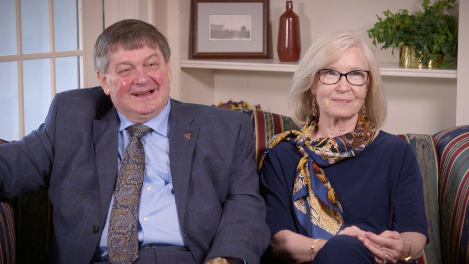 Glenda Chatham and Robert G. Clarke sitting on a couch looking at camera.