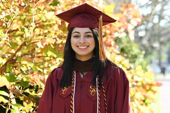 student in regalia during commencement