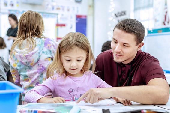 Student working with child