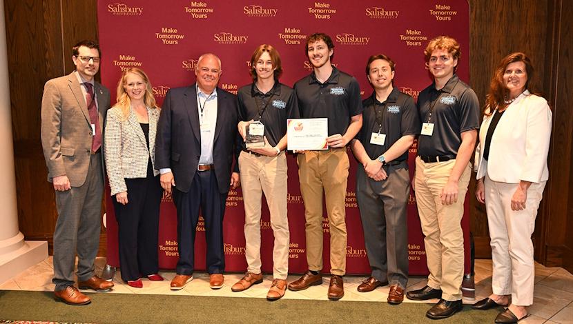 Housing Co. recieving award along with faculty/staff presenting award