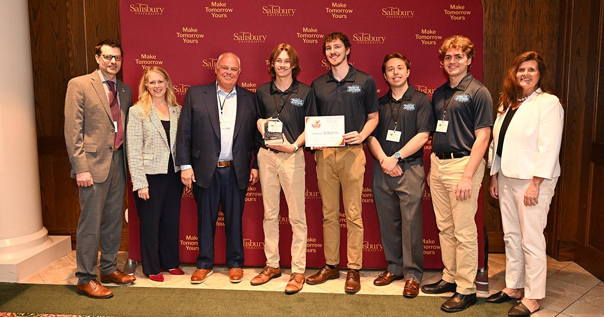 Housing Co. recieving award along with faculty/staff presenting award