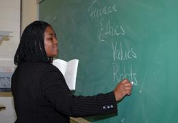 teacher writing on chalkboard