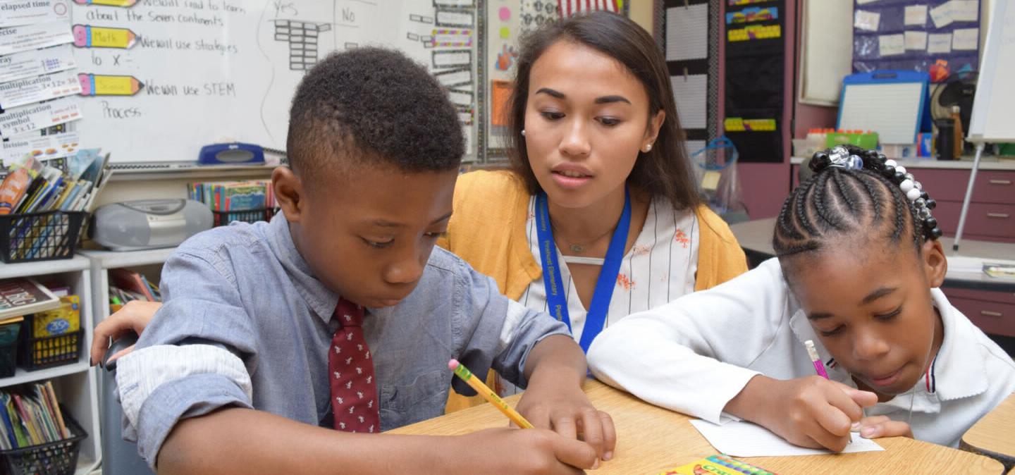 A Salisbury University education major instructing a young student