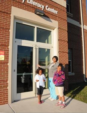 Student and children standing outside the May Literacy Center