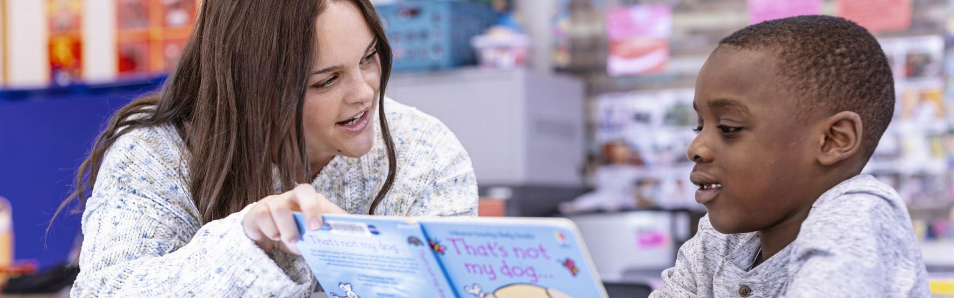 A Salisbury University education major instructing a young student