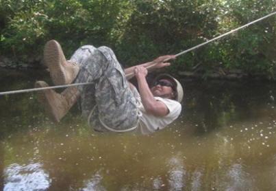 A cadet demonstrating an individual movement technique across a rope bridge