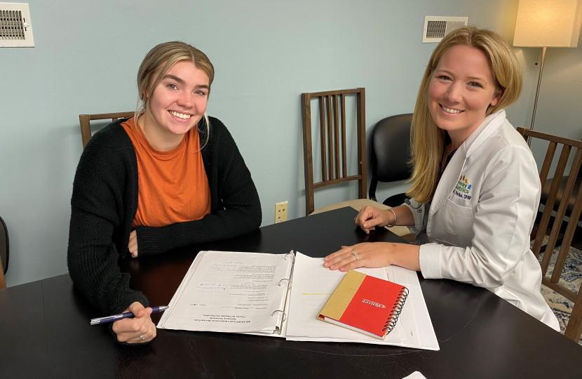 Professor and Student at Desk