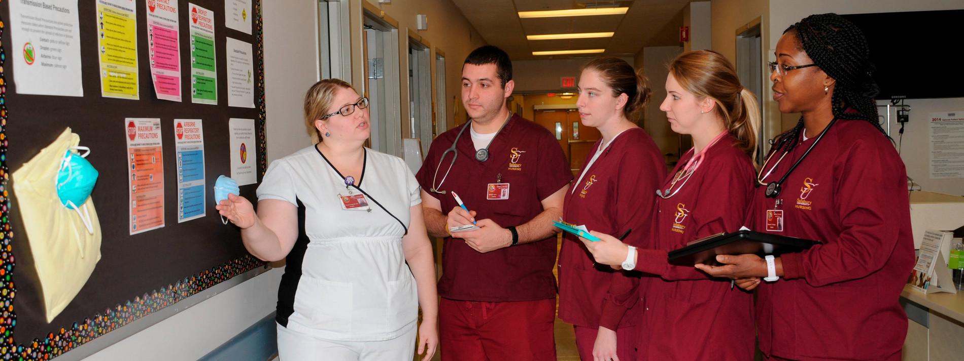 An instructor at Salisbury University Nursing School in Maryland takes students on a hospital tour