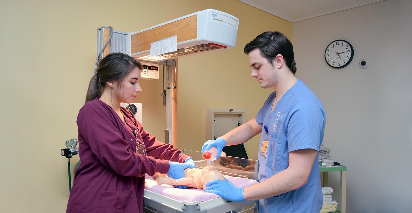 Two Salisbury University Students work on Resuscitation Newborn Mannequin
