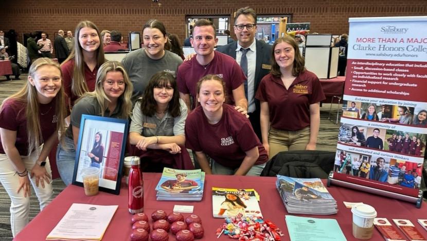 Honors Dean and Students pose at exhibit table