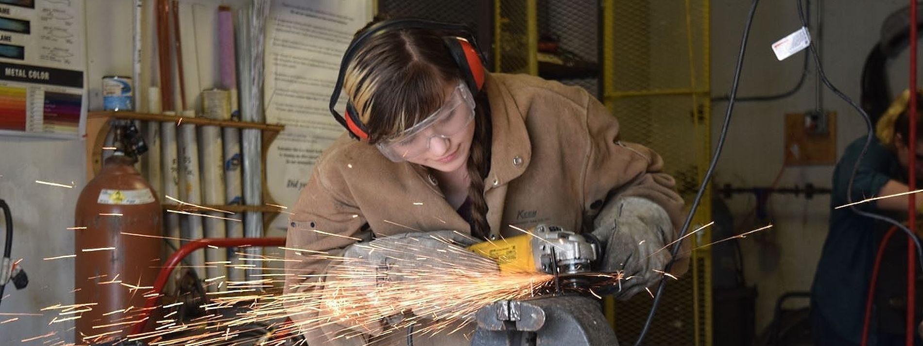 student working in metal shop
