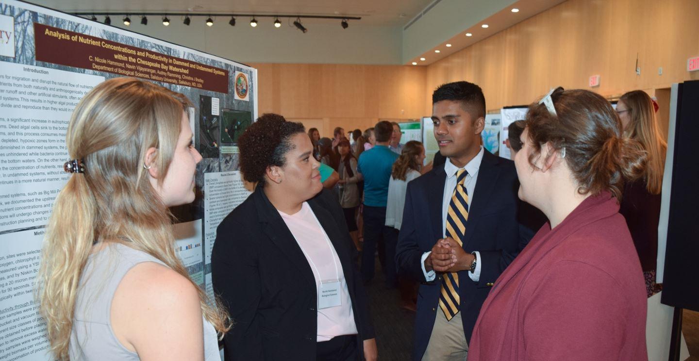 students discussing work at undergraduate research conference
