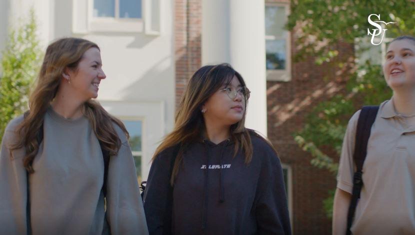 video image 3 students walking on campus