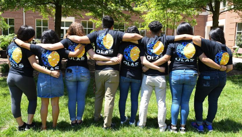 Group photo of OLAS club showing off shirts