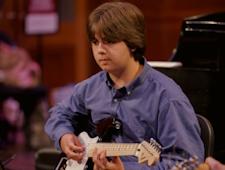 Young student playing guitar