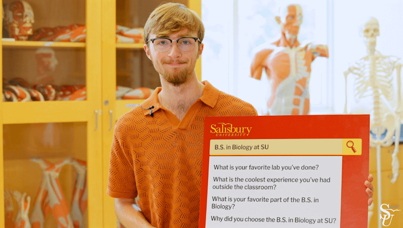 Student holidng FAQ sign 