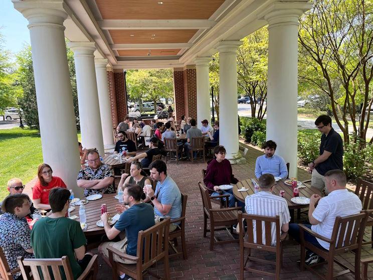 Faculty and students enjoying food on the patio