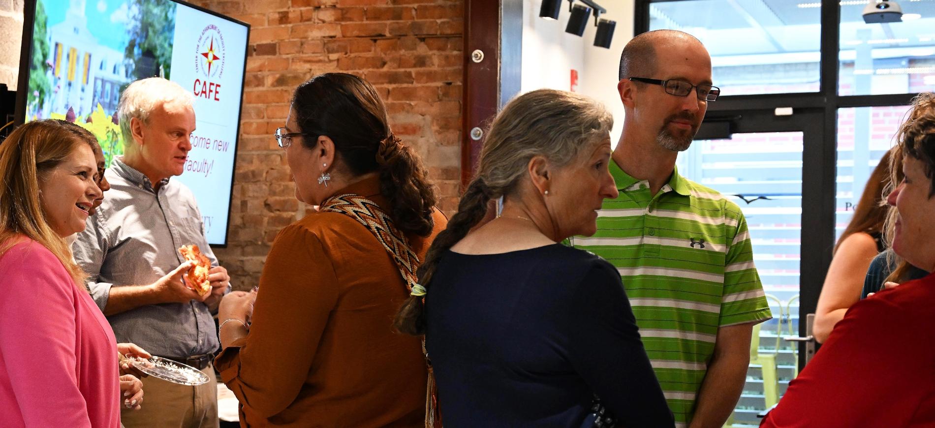 Group of faculty at tables