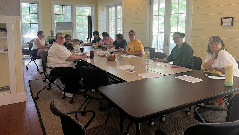 SU Wise at group at a table