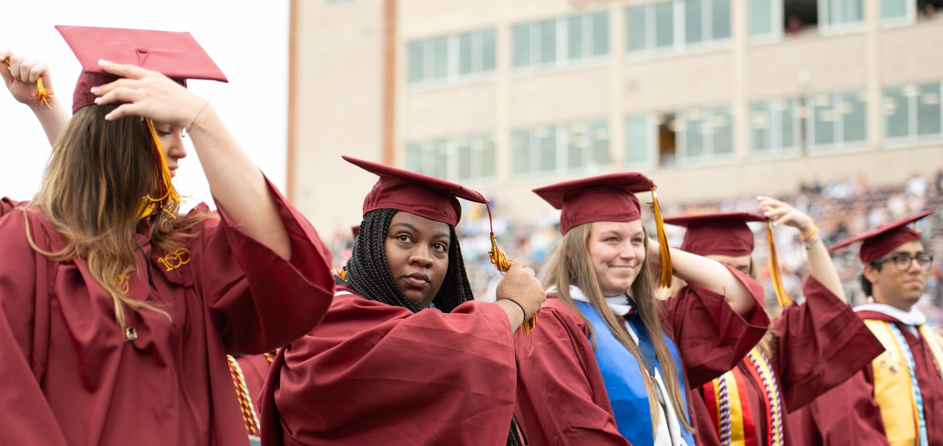 Four students smiling at graduation