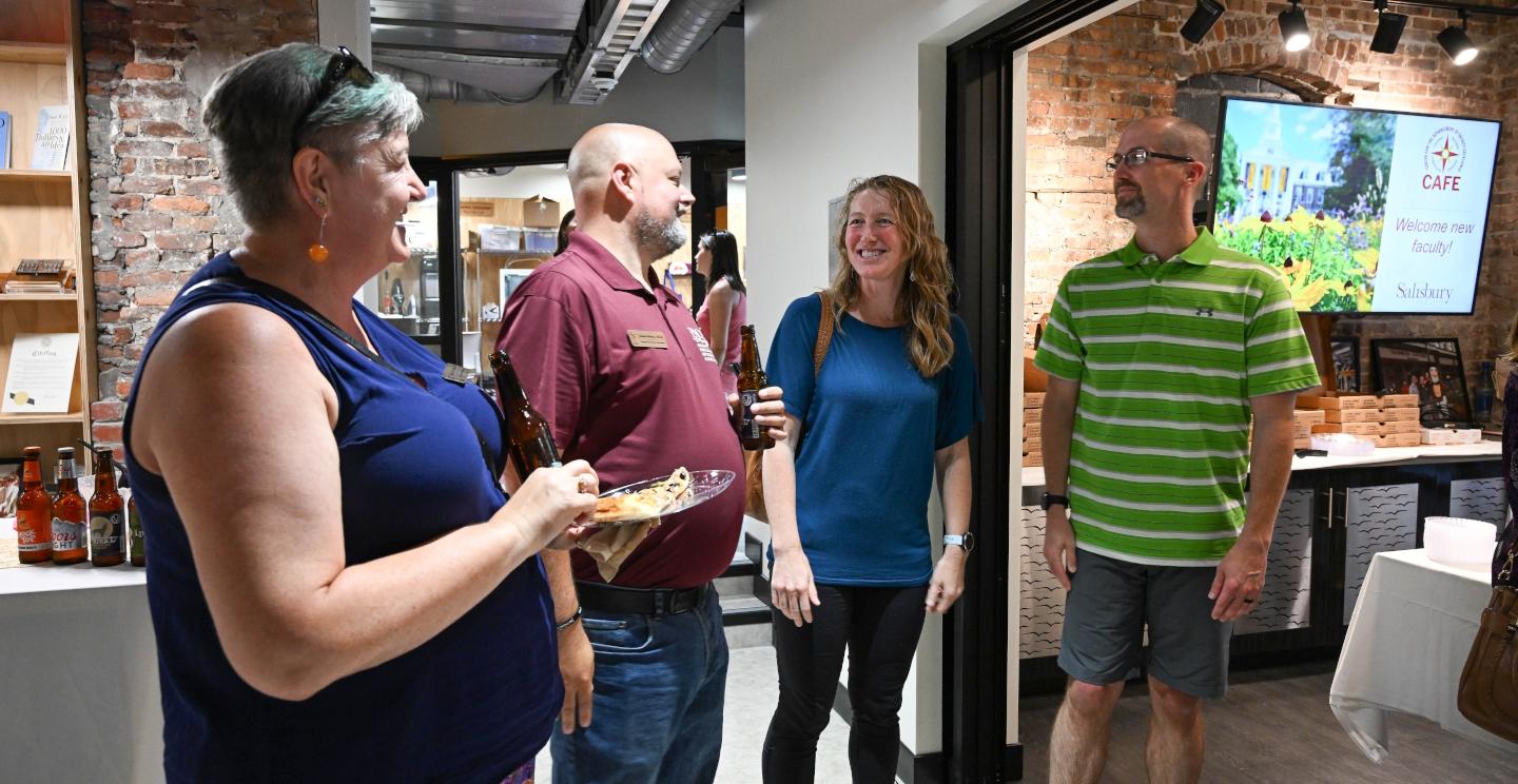 Faculty members converse at an event