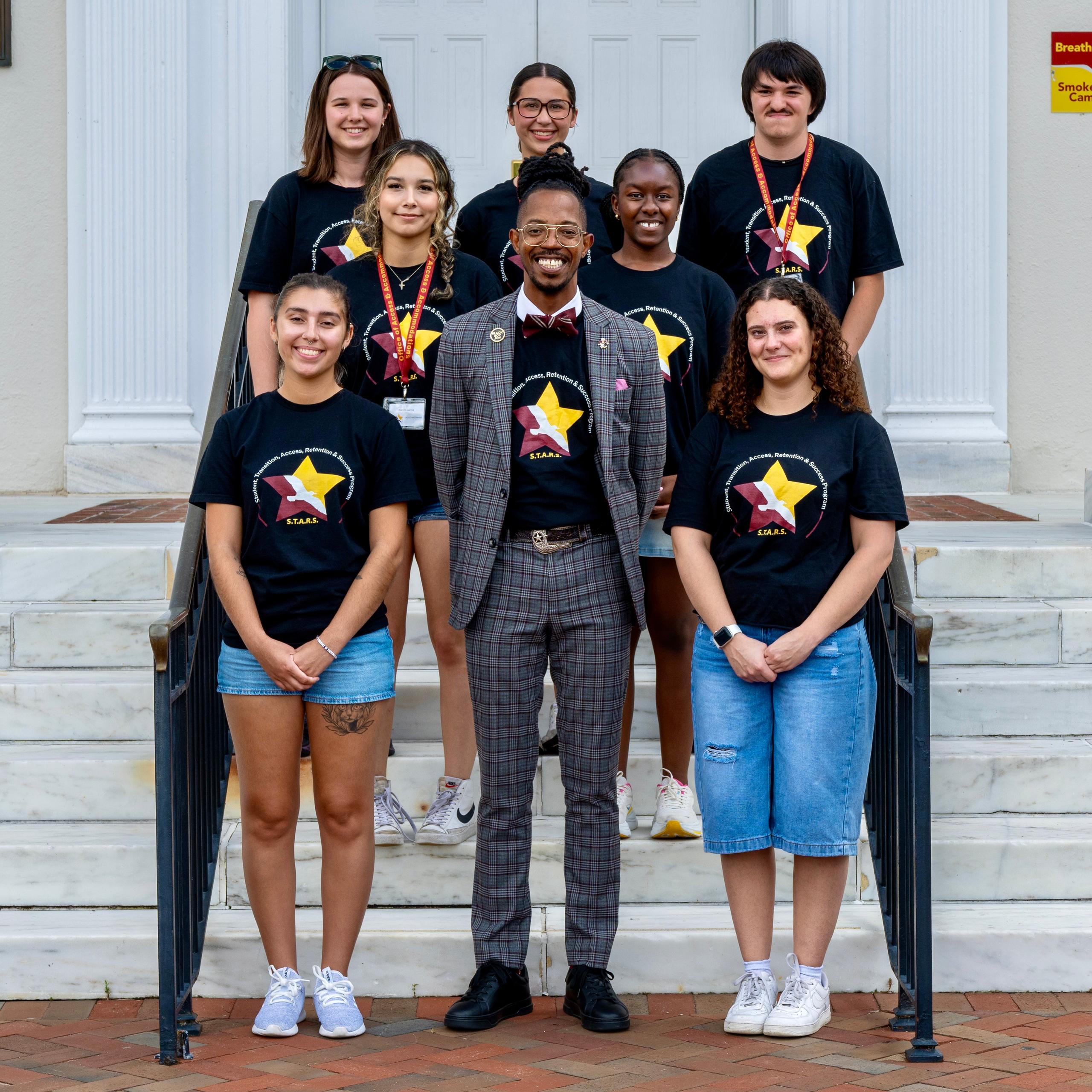 Eight members of ����ֱ��’s S.T.A.R.S. program pose together on campus steps, smiling and wearing S.T.A.R.S. shirts.