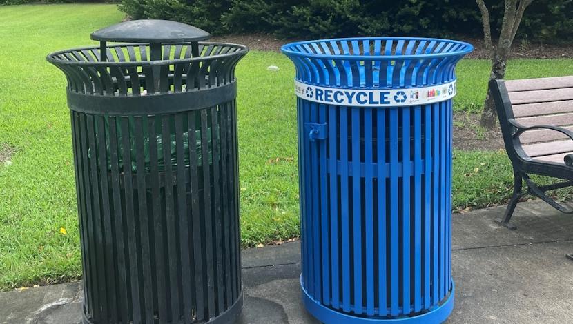 Two metal containers one for trash and one for recycling