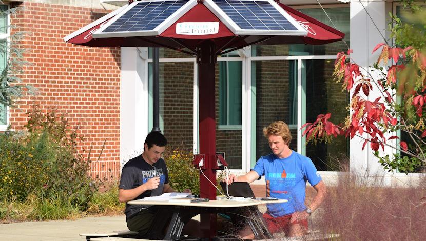 Students sitting at solar table