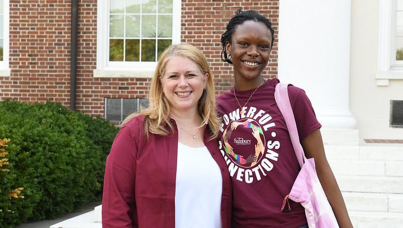 Student outside Holloway Hall with President Lepre