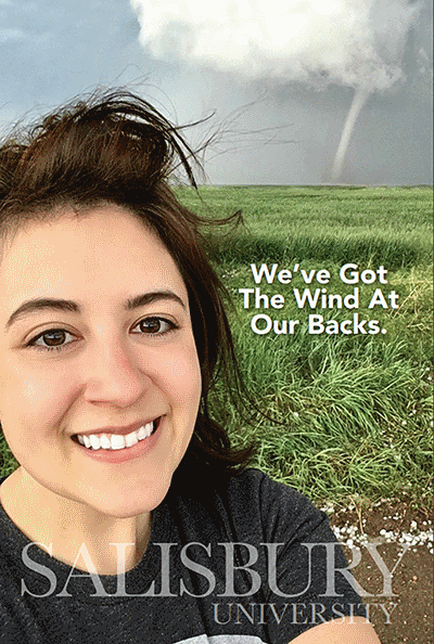 SU Spotlight Cover for 1st edition. SU student stands in field with tornado in background overlay text reads "We've Got The Wind At Our Backs"