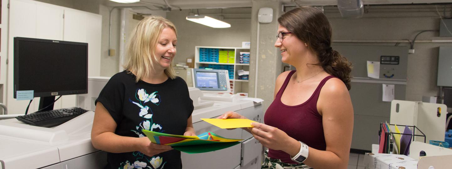 student picking colored paper at copy center