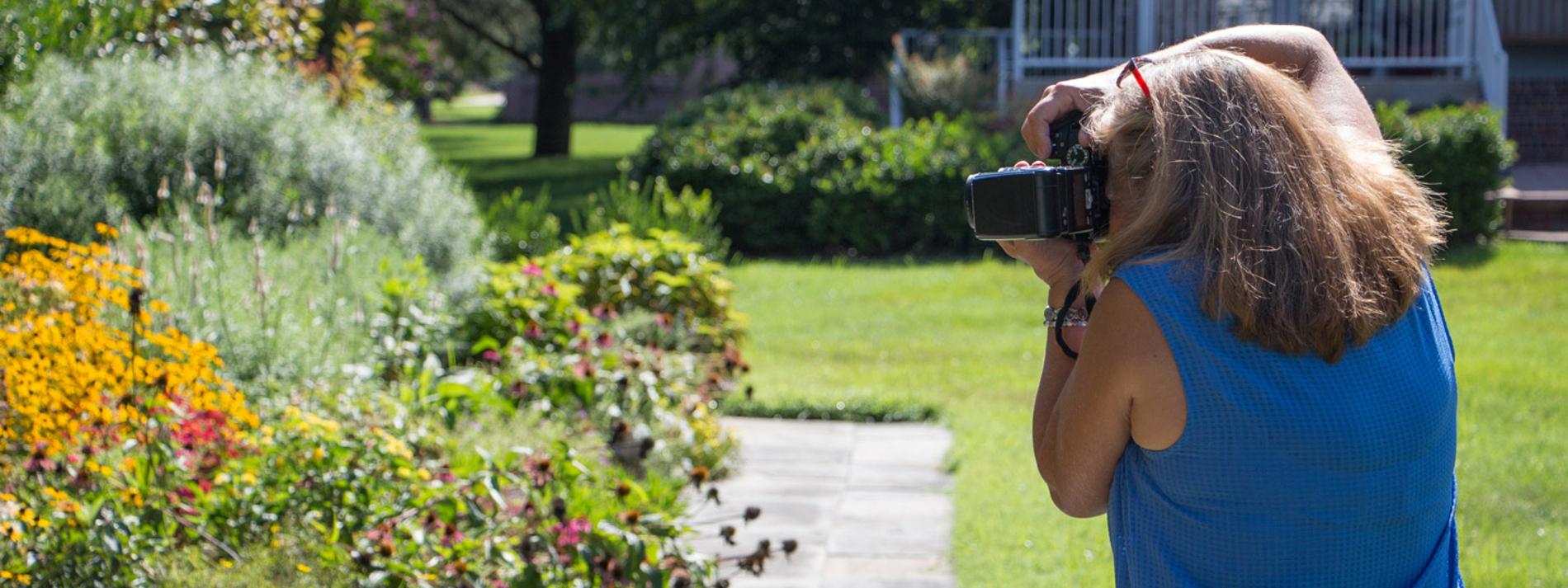 Photographer photographing flowers