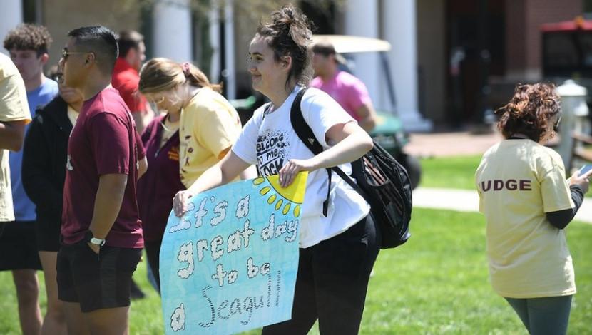 Students holds a sign that says "#1 Seagull Fan"