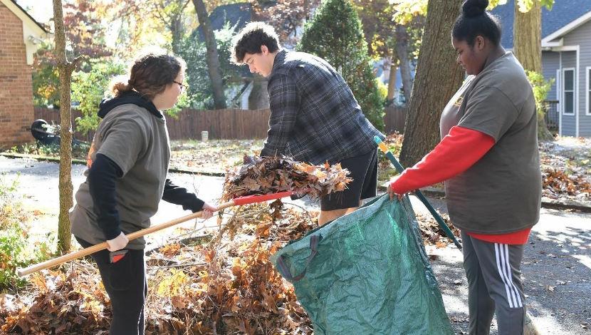 Student volunteers helping neighbors with yard work