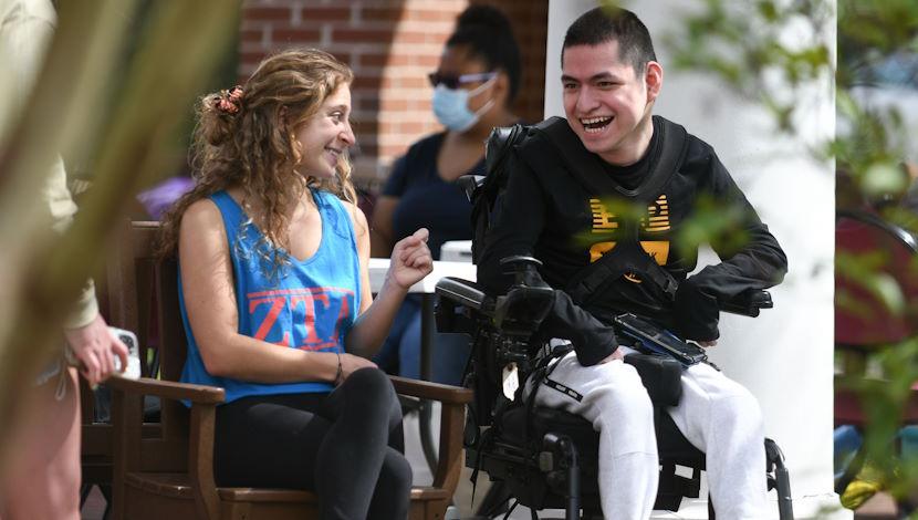 Student volunteer with person in wheelchair