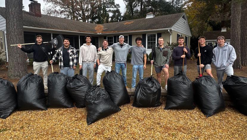 Theta Chi students doing yard work
