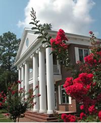 University building with red flowers