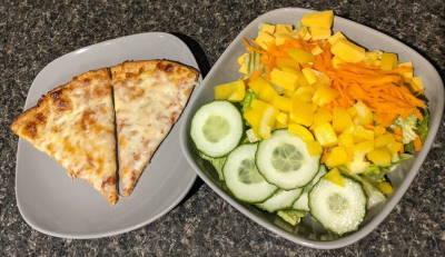Two slices of pizza and a veggie bowl