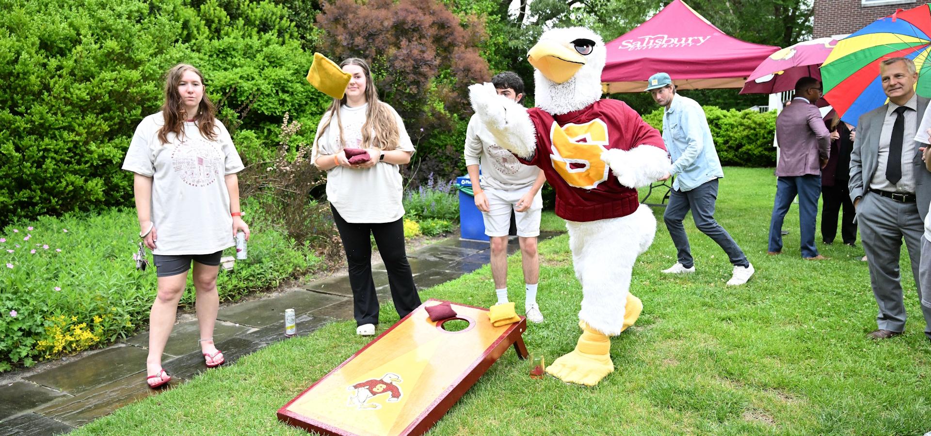 Senior send off event that shows students playing cornhole with Sammy the Seagull