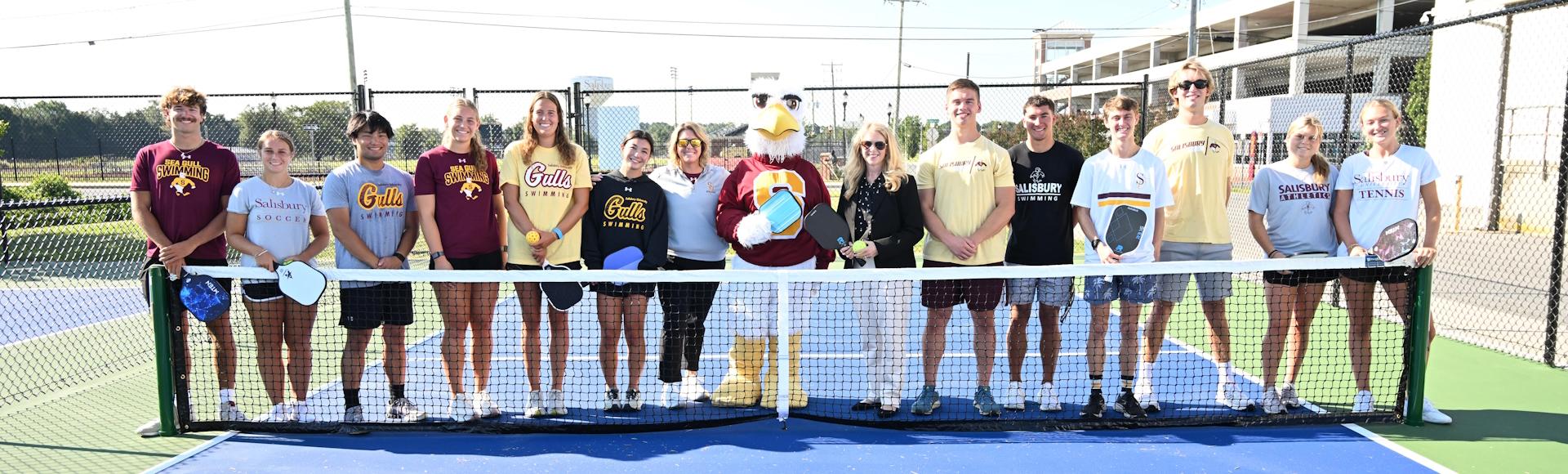 Group photo of President Lepre with students on the pickleball courts