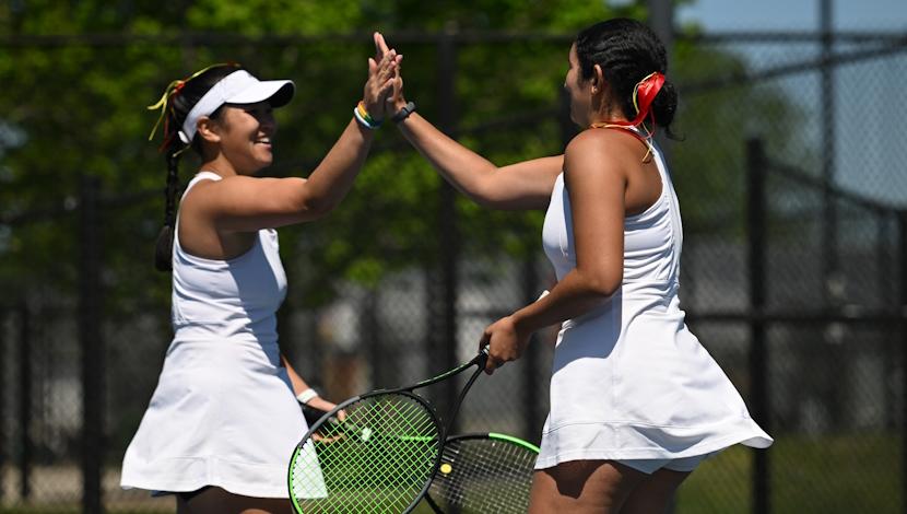 Two tennis players high five