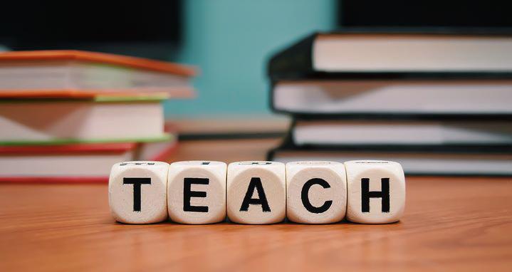 Blocks in the ֱ education department that spell out teach