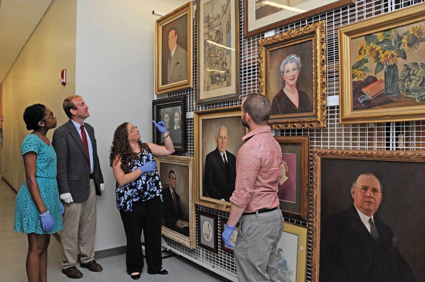 Student earning her master's of history group guides a group through a studio