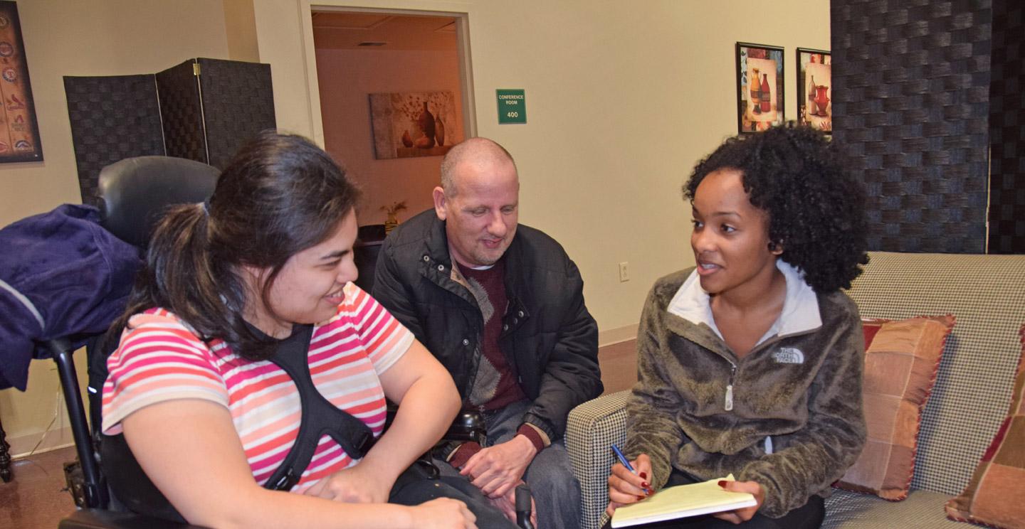 Student seeking a social work degree speaking with girl in wheelchair