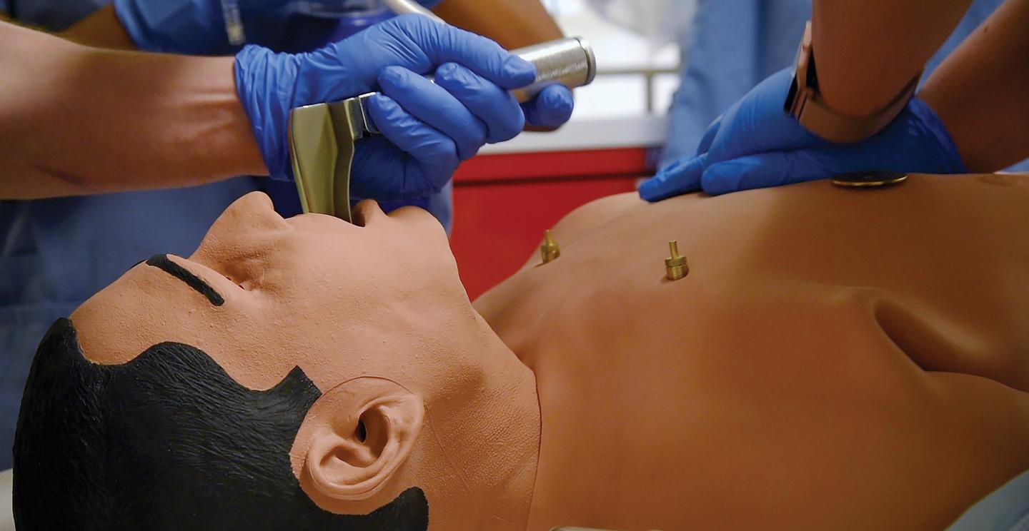 Respiratory Therapy Major using a test dummy with face mask in SIM center