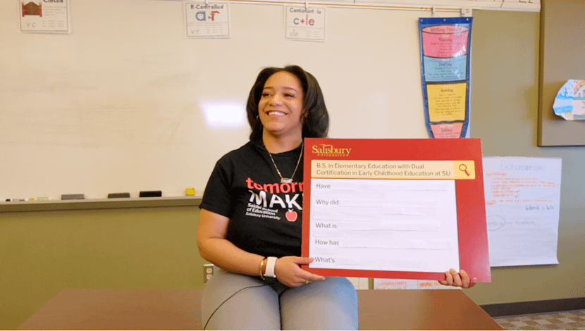 Amari Silva holding a sign that says B.S. Education Dual Certification at Salisbury University