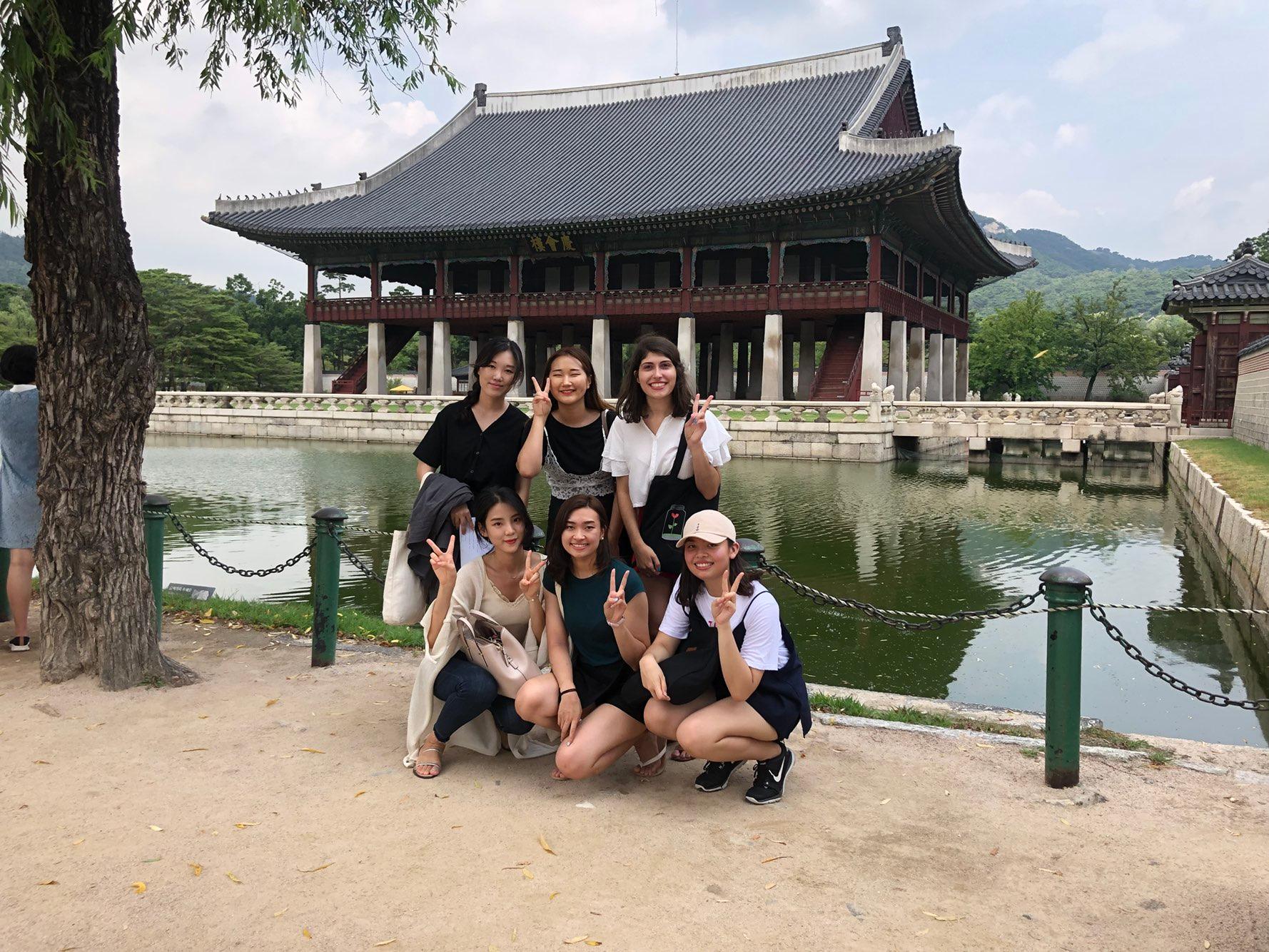 6 students in front of a Chinese pagoda.