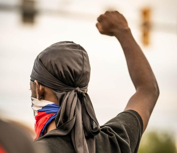 Young man with his fist raised in solidarity 