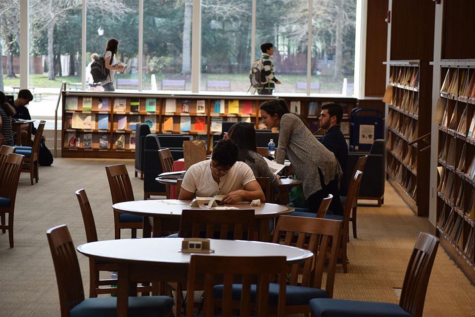 Students studying at tables in the Pit